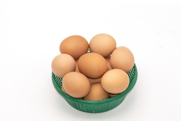 Close up eggs in a green basket isolate on white background. Select focus.