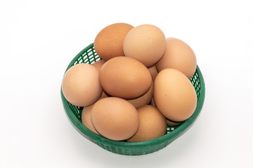 Close up eggs in a green basket isolate on white background. Select focus.