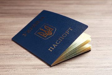 Ukrainian internal passport on wooden background, closeup