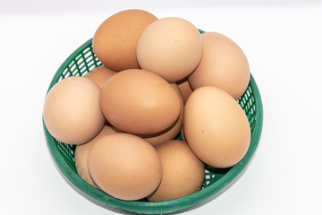 Close up eggs in a green basket isolate on white background. Select focus eggs..