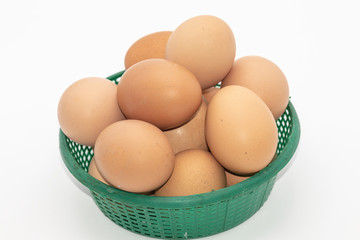 Close up eggs in a green basket isolate on white background. Select focus.