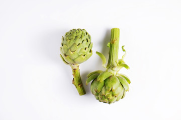 Fresh green Italian Artichoke isolated on white background. Organic local produce vegetable. Vegan diet. Clean eating concept. Close up, top view, flat lay.