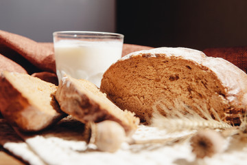 Loaf of bread with milk on table, beautiful healthy food - still life
