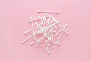 pile of white cotton sticks, swabs on pink background