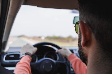Young man driving a car, interior shot
