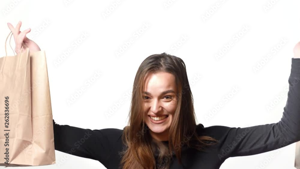 Wall mural Young woman with shopping on white background