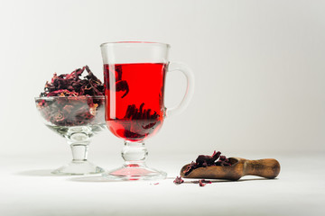 Transparent glass Cup with hot red tea from hibiscus or hibiscus.