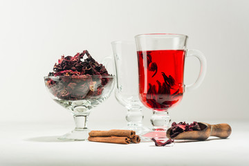 Transparent glass Cup with hot red tea from hibiscus or hibiscus.