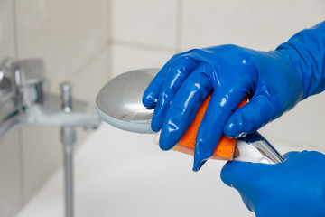 Close-up of shower mixer faucet with limescale, white chalky deposit and stains. Formed on the...