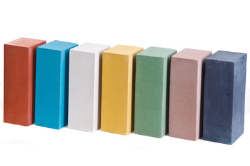 Set of multi-colored ceramic bricks in formation at the white background, isolated