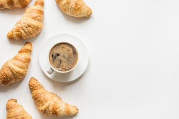 Cup of coffee and freshly baked croissants. Top view. Copy space.