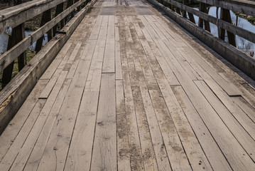 View of the wooden bridge across the moat around the Shlokenbek estate in Latvia. 7 April 2019.