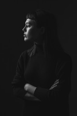 Attractive young woman in studio. Profile. Black and white
