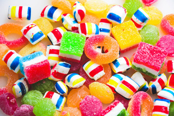 different colored round candy. Top view. Candy background. A lot of colorful candy. Pile of delicious colorful chewing candies as background