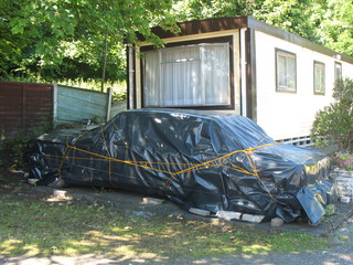 old car under a tarpaulin