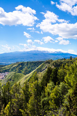 Fototapeta na wymiar Etna volcano (vulcano) view, Sicily island, Italy. Bright summer sky with clouds. 