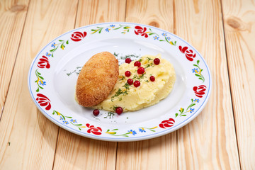 cutlet with mashed potatoes on the wooden background