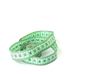 Tailoring centimeter tape twisted into a spiral isolated on a white background.