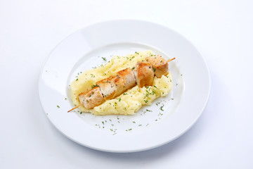 chicken kebab with mashed potato on the white plate