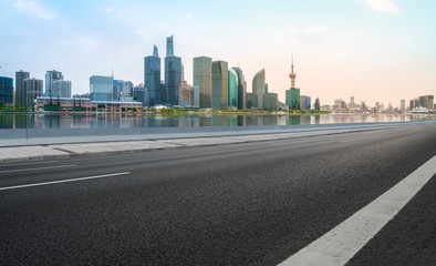 Fototapeta na wymiar Empty Asphalt Road Through Modern City of Shanghai, China..