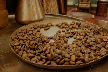 Black coffee beans  in an old copper tray