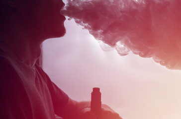 vape man closeup produces a cloud of steam
