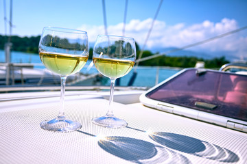 Pair of wineglasses against the yacht