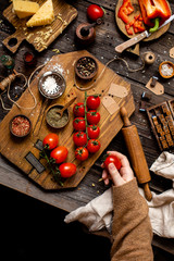 Overhead shot of branch ripe cherry tomatoes on wooden board 