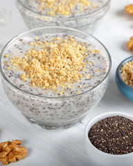 Chia pudding made with milk, banana and decorated with walnut