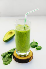 Green spinach and avocado smoothies. Detox drink on white table