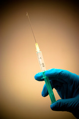 Medical hand holds syringe and vaccine	