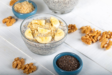 Chia pudding made with milk, banana and decorated with walnut