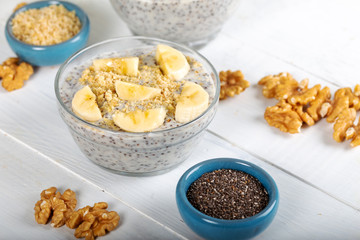Chia pudding made with milk, banana and decorated with walnut