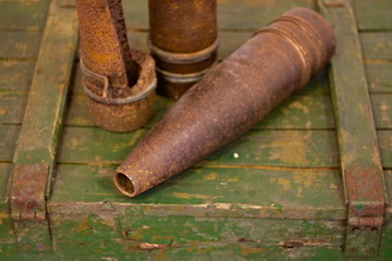The old artillery shells lie in wooden box