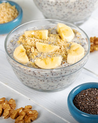 Chia pudding made with milk, banana and decorated with walnut