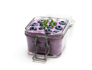 Fresh blueberries yogurt in glass jar isolated on white