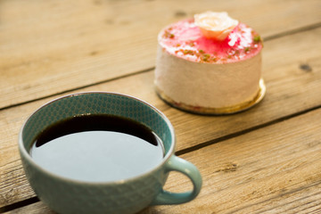 cup of coffee and cookies on wooden table