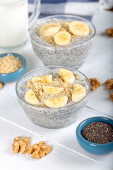 Chia pudding made with milk, banana and decorated with walnut