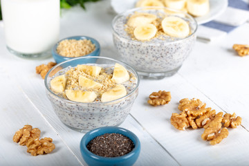 Chia pudding made with milk, banana and decorated with walnut