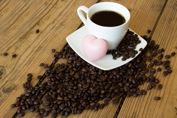 cup of coffee and beans on wooden table