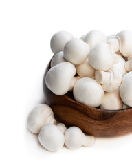 Fototapeta na wymiar Fresh mushrooms in wooden bowl isolated on white