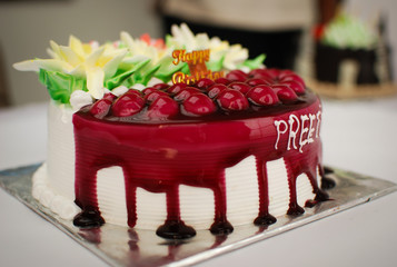 A birthday cake of chocolates on a white background 