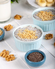 Chia pudding made with milk, banana and decorated with walnut