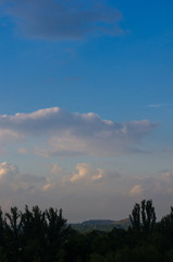 Landscape with dramatic light - beautiful golden sunset with saturated sky and clouds.