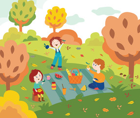 Children friends at picnic outdoors in autumn park or garden with colorful tree leaves.