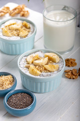 Chia pudding made with milk, banana and decorated with walnut