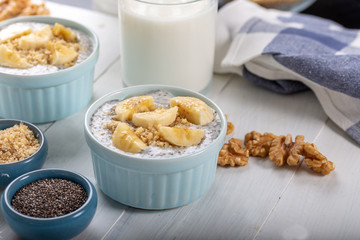 Chia pudding made with milk, banana and decorated with walnut