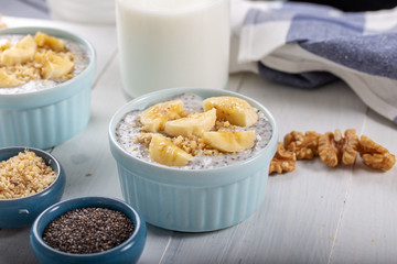 Chia pudding made with milk, banana and decorated with walnut