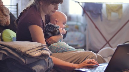 Mother with her baby using laptop