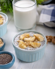 Chia pudding made with milk, banana and decorated with walnut